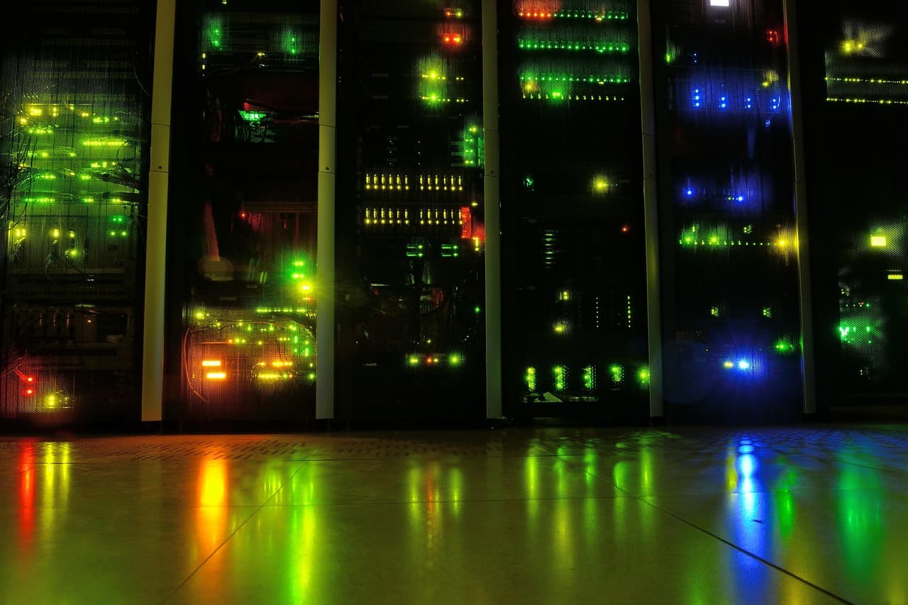 Rows of illuminated server racks in a data center, representing the hyperscaler, enterprise, and sovereign AI infrastructure that Nvidia's chips supply.