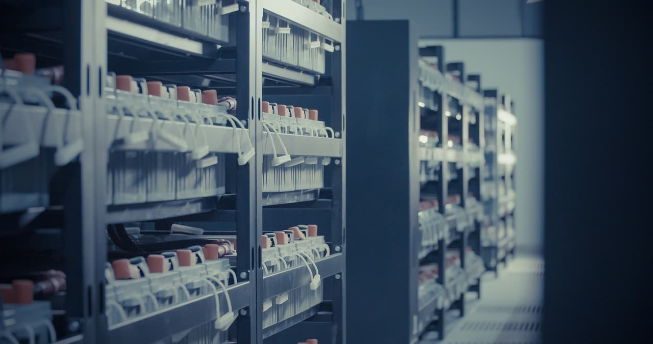Rows of industrial data center infrastructure and cabling, representing the GPU cloud capacity CoreWeave is racing to build for AI customers.