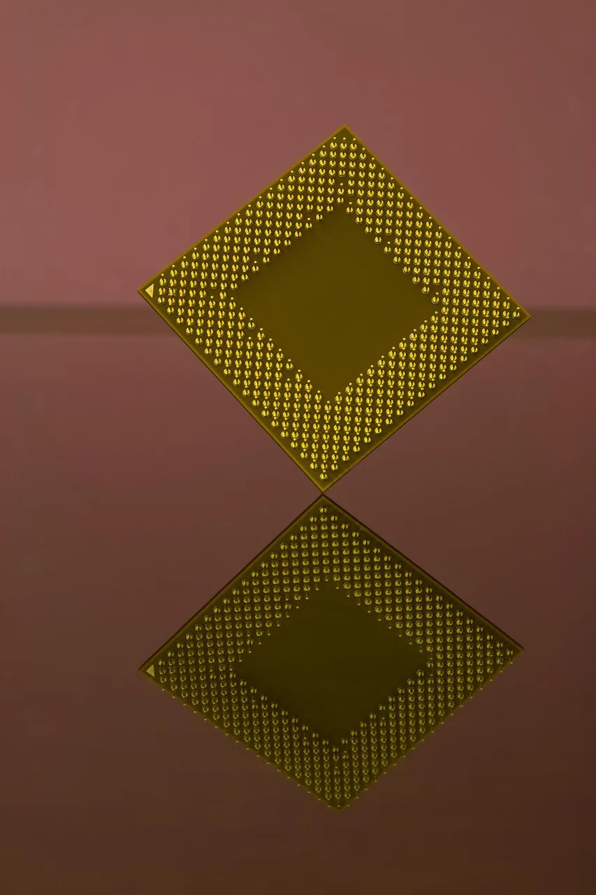A macro view of densely packed circuit board components and a central processor, representing the semiconductor supply constraints shaping AI infrastructure spending.
